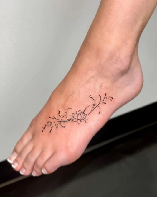 Small Ornamental Lotus Vine Tattoo on Women Foot by @sn.inks