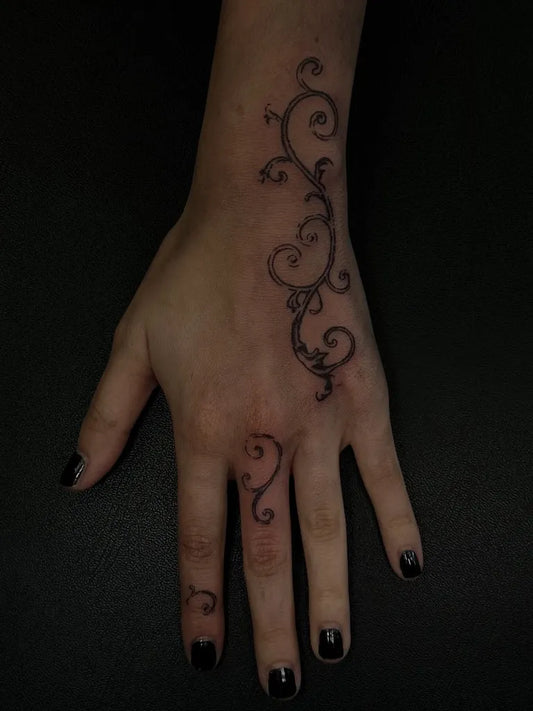 Small Ornamental Vine Tattoo on Women Hand by @whisperinkz