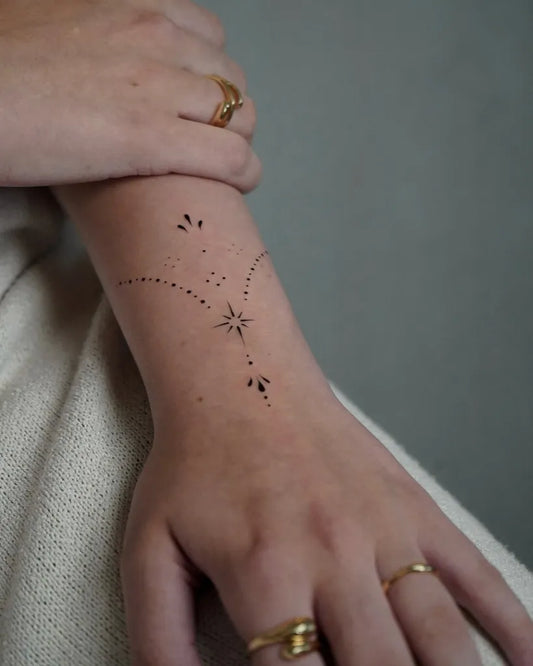 Small Ornate Star Chain Tattoo on Women Wrist by @the.xx.ttt