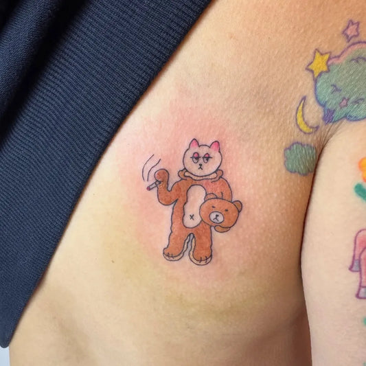 Small Outline Cat Riding Bear Tattoo on Women Arm by @tattooistyuan