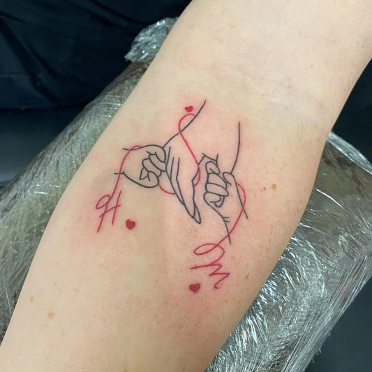 Small Outline Linked Fists With Red String Tattoo on Women Arm by @seven_sins_tattoo