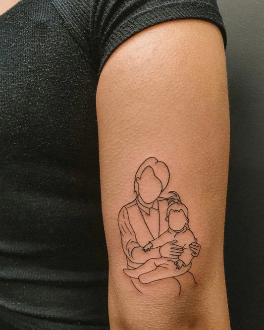 Small Outline Mother Holding Child Tattoo on Women Arm by @hybridink.helsinki