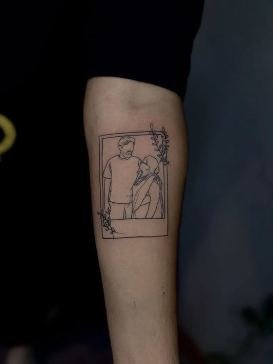 Small Outline Polaroid Frame with Couple and Foliage Tattoo on Women Arm by @rain__tattoo
