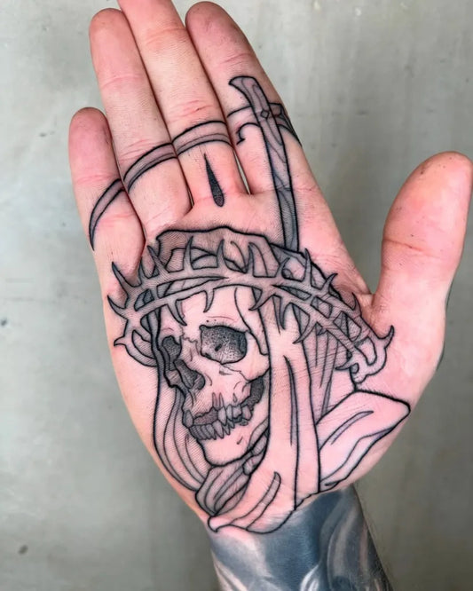 Small Outline Skull with Crown of Thorns and Sword Tattoo on Men Hand by @lukeaashley