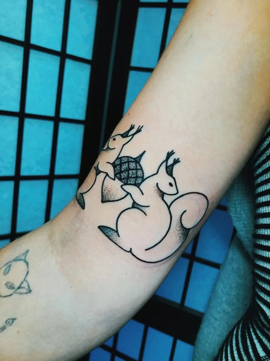 Small Outline Two Squirrels With Acrob Women Arm by @foxy.tattoos