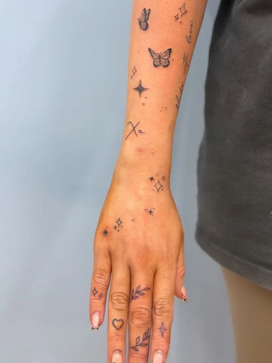 Small Patchwork Butterflies stars crosses on Women Arm Tattoo by @amieelizabeth_tattoos