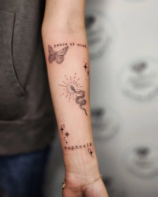 Small Patchwork Butterfly Snake Text on Women Arm Tattoo by @paulinaa.tattoo