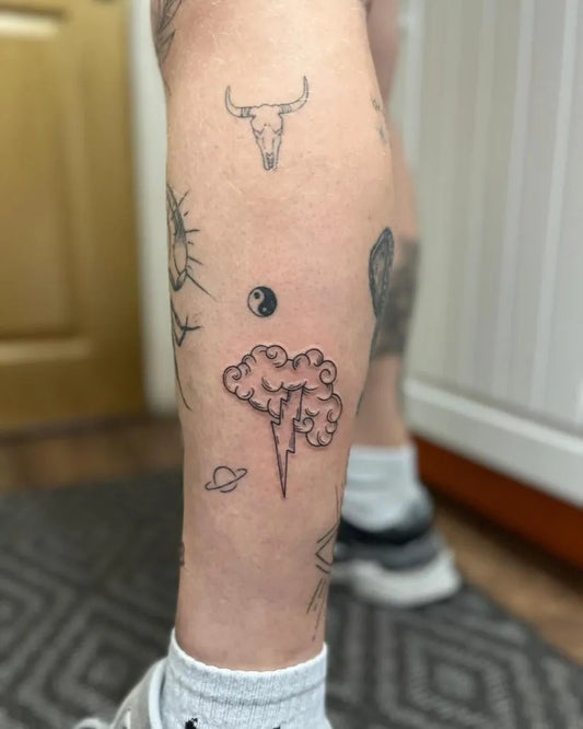 Small Patchwork Clouds and Lightning on Men Leg Tattoo by @tbt_is_love_tattoo