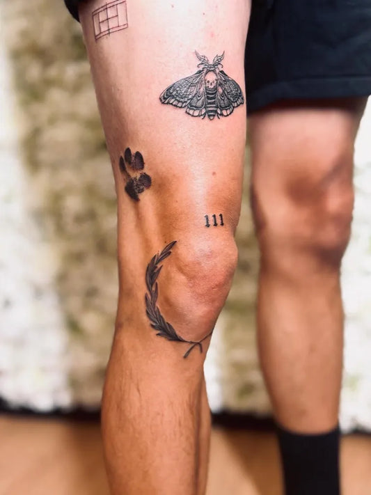 Small Patchwork Moth Laurel Wreath Roman Numerals on Men Thigh Tattoo by @tattoo_blacksparrow
