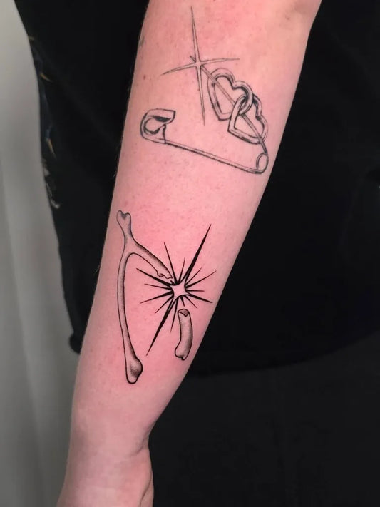 Small Patchwork Safety Pin with Heart Bone with Starburst on Women Arm Tattoo by @gumptiongirltattoo