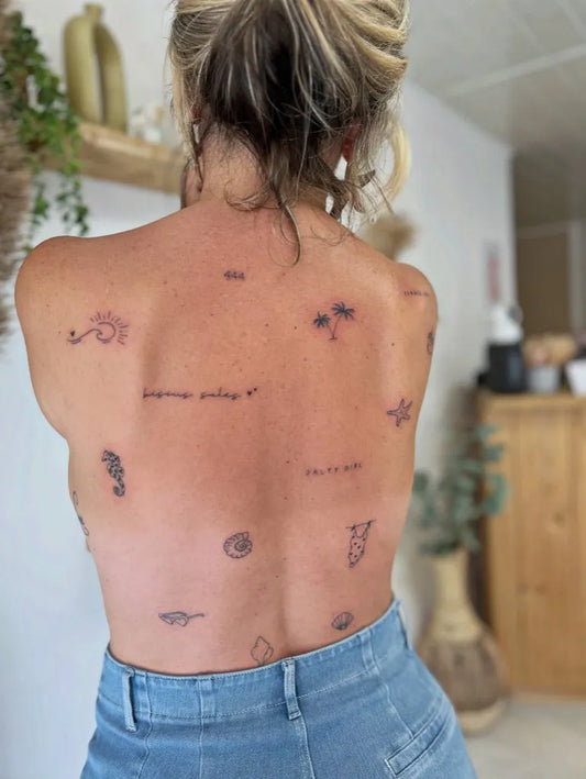 Small Patchwork SunButterflyStarfish on Women Back Tattoo by @lapetaledencre