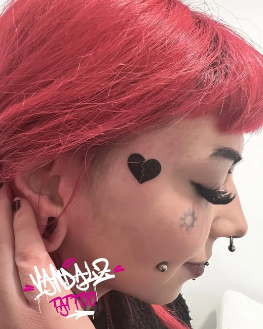 Small Punk Heart Sun on Women Face Tattoo by @vandalztattoo
