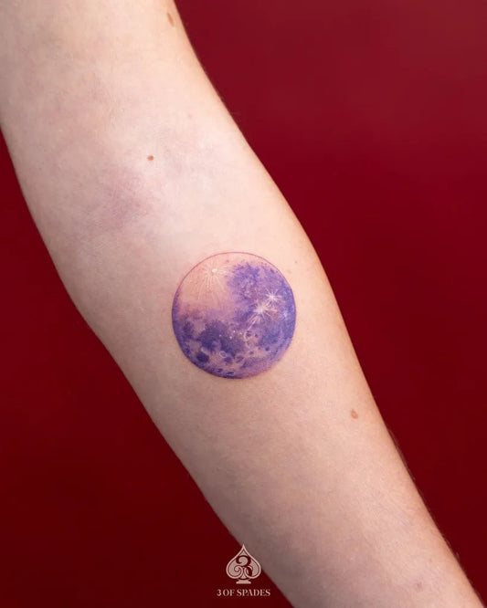 Small Purple Moon Tattoo on Women Arm by @3ofspades.tattoo