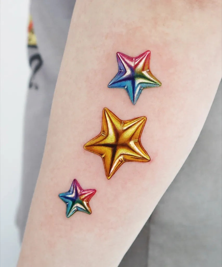 Small Rainbow Gold Star Tattoo on Women Arm by @jooa_tattoo