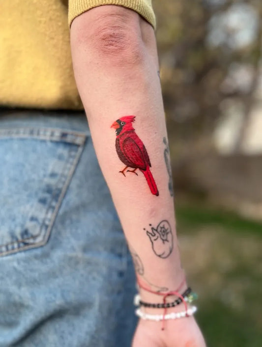 Small Realism Cardinal Tattoo on Women Arm by @ozguryesilbas.tattoo