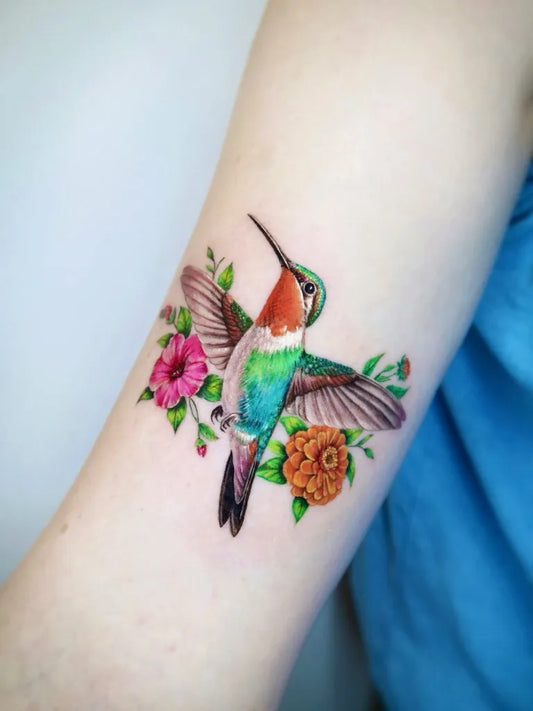 Small Realism Hummingbird and Flowers on Women Arm Tattoo by @mica.tattoos