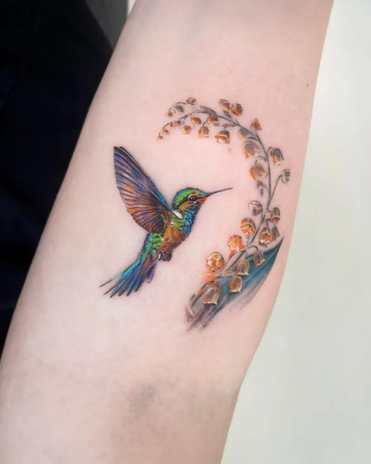 Small Realism Hummingbird and Lily of the Valley on Women Arm Tattoo by @minen_skin_painter