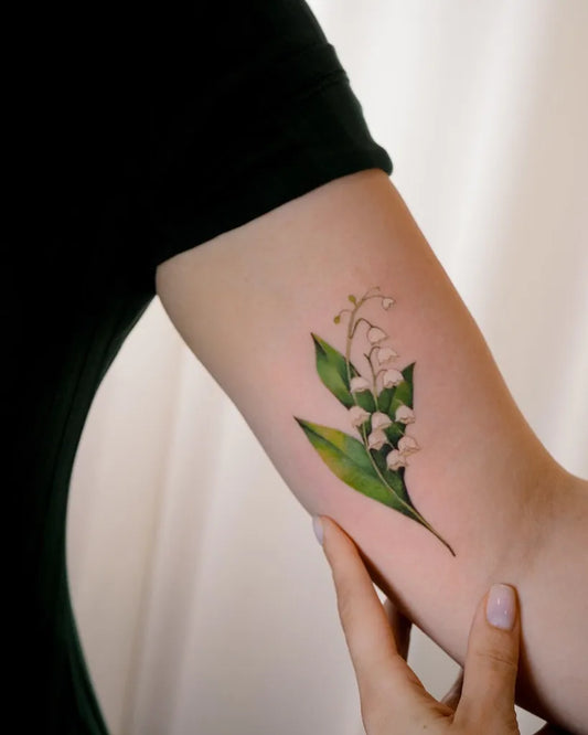 Small Realism Lily of the Valley Women Arm Tattoo by @yuliia_flower_tattoo