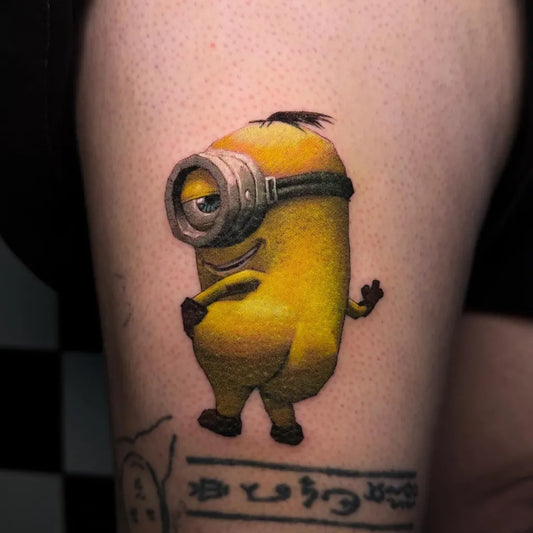 Small Realism Minions Character Cartoon Tattoo on Women Thigh by @txttoo