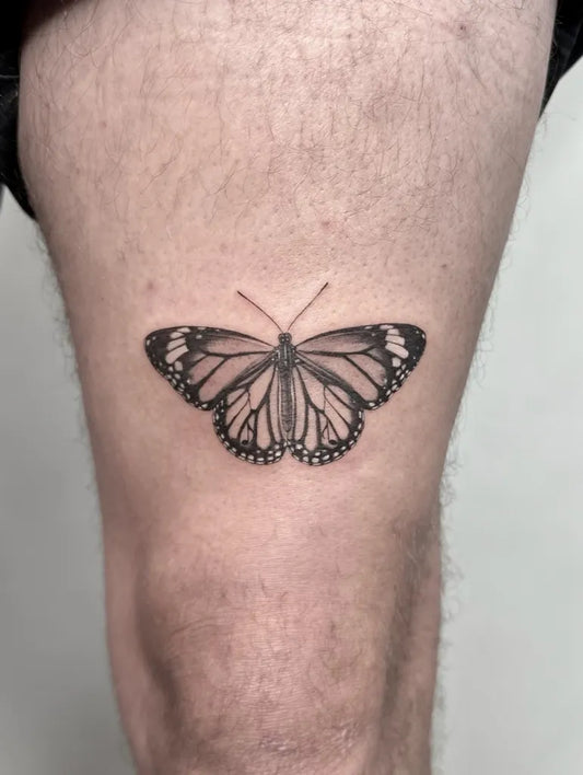 Small Realism Monarch Butterfly Tattoo on Men Thigh by @finelinecosmetics.tattoo