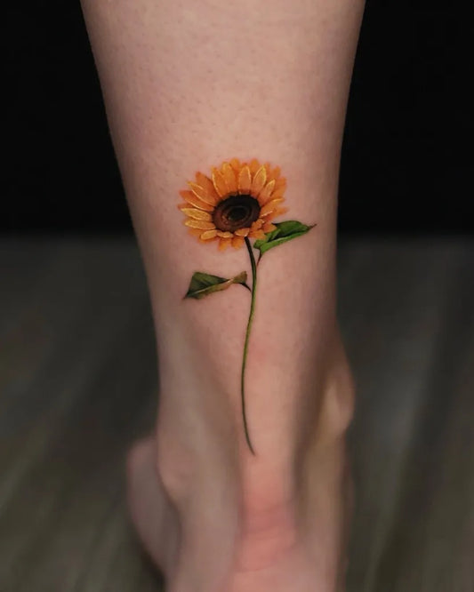 Small Realism Sunflower on Women Ankle Tattoo by @tattooist_yum