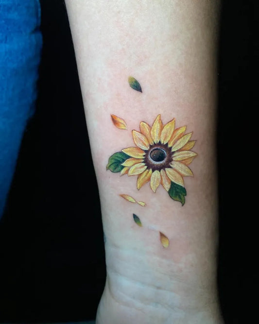Small Realism Sunflower with Leaves on Women Arm Tattoo by @rondasancheztattoo