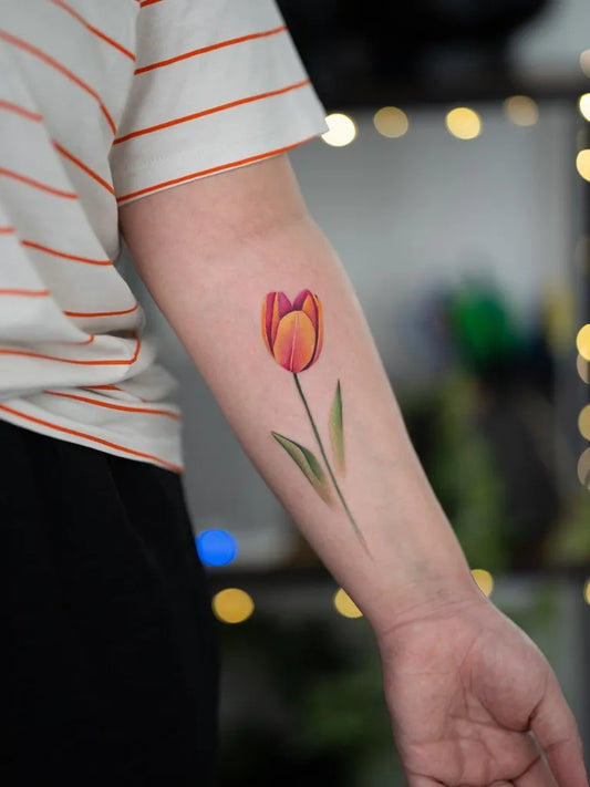 Small Realism Tulip Tattoo on Women Arm by @fat_cat.tattoo