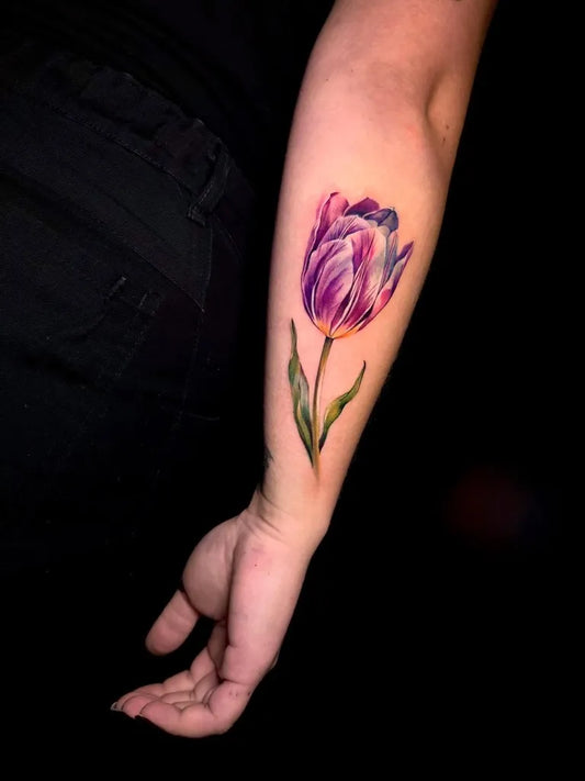 Small Realism Tulip Tattoo on Women Arm by @shuster.tattooer