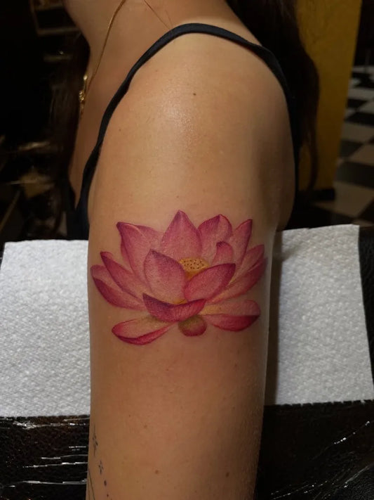 Small Realistic Pink Lotus on Women Shoulder Flower Tattoo by @francescadenirotattoo