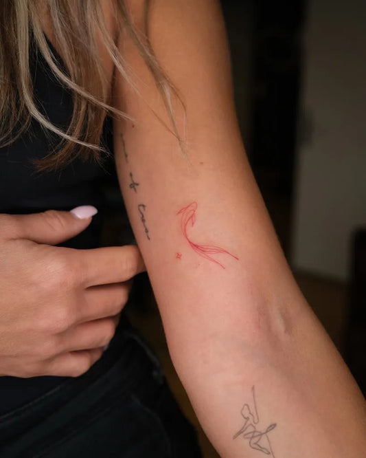 Small Red Bird and Text Tattoo on Women Arm by @luprosil