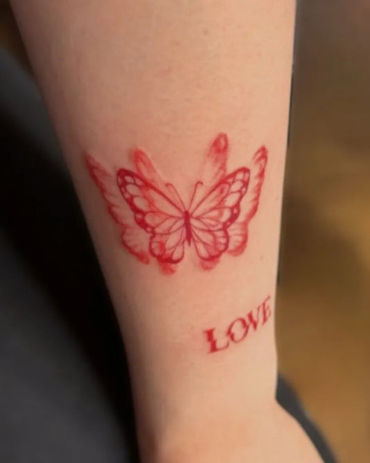 Small Red Butterfly Tattoo on Women Forearm by @sanctuminkhouse