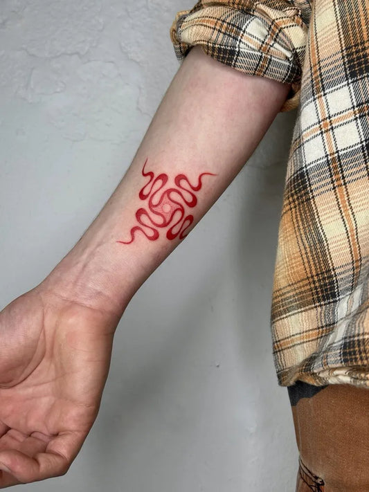 Small Red Endless Knot Tattoo on Men Arm by @nina_nathalie