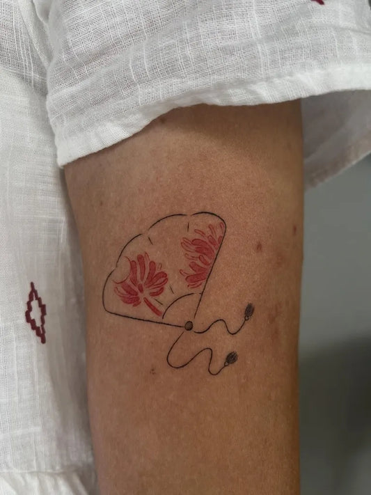 Small Red Fan Tattoo on Women Arm by @faunus.tattoo