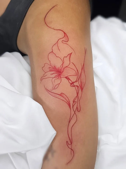 Small Red Flowers Tattoo on Women Arm by @farone.tattoo