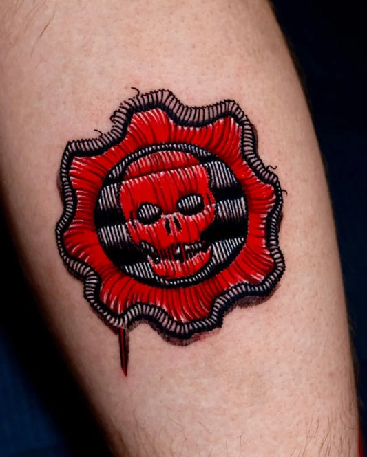 Small Red Gear Skull Tattoo on Men Arm by @orlandokingstattoo