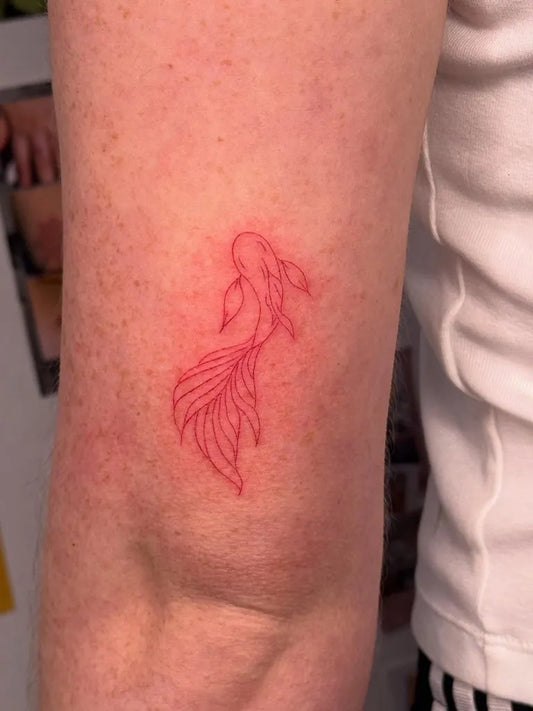 Small Red Goldfish Tattoo on Women Arm by @ashmoth_ink