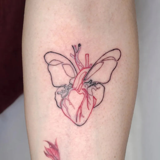Small Red Heart with Butterfly Wings Tattoo on Women Forearm by @ink.papapa