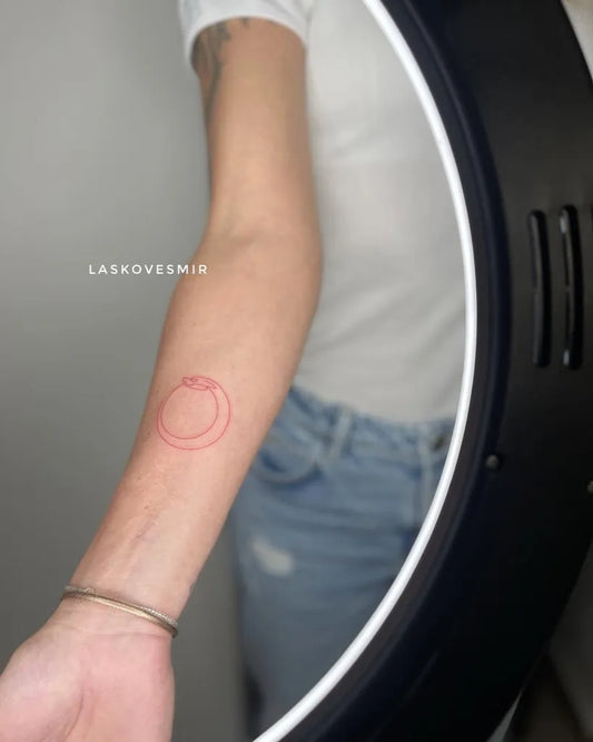 Small Red Outline Ouroboros Tattoo on Women Forearm by @laskovesmir