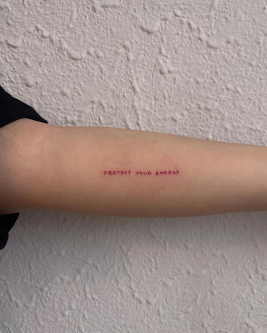 Small Red Protect Your Energy Tattoo on Women Arm by @maria.ms.sousa