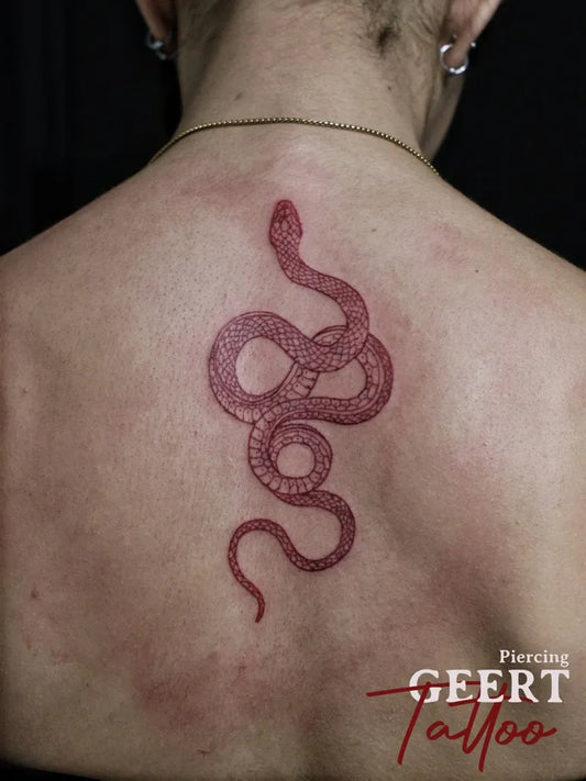 Small Red Snake Tattoo on Women Back by @geert_tattoo_piercing