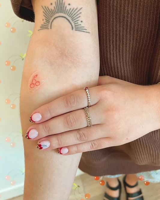 Small Red Sun and Cherries Tattoo on Women Arm by @lexibkip