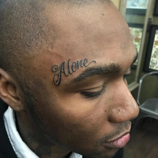 Small Script Alone on Men Face Tattoo by @_tattoosbyshon_