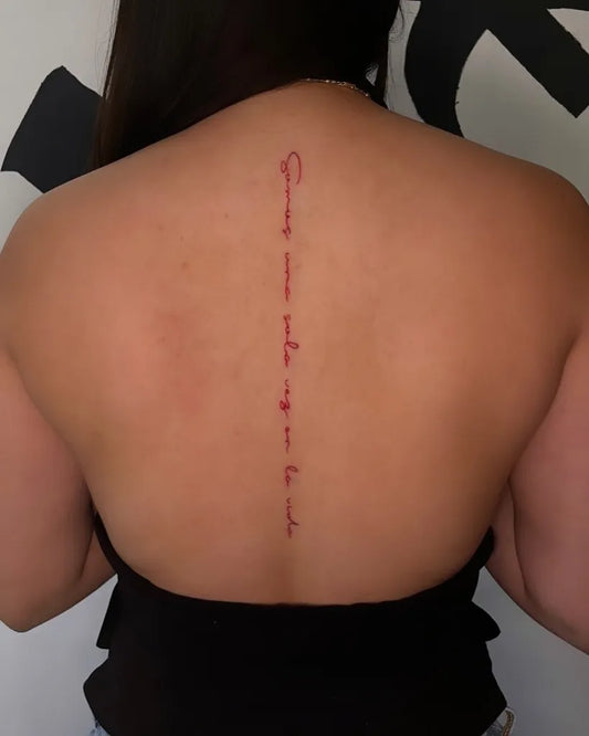 Small Script Foreign Text on Women Back Tattoo by @inktatts_tattoostudio