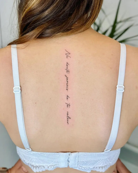 Small Script Latin Text on Women Spine Tattoo by @reze_tattoo_joce