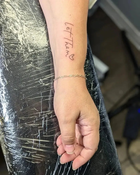 Small Script Let Them Heart on Women Forearm Tattoo by @candiceperryart