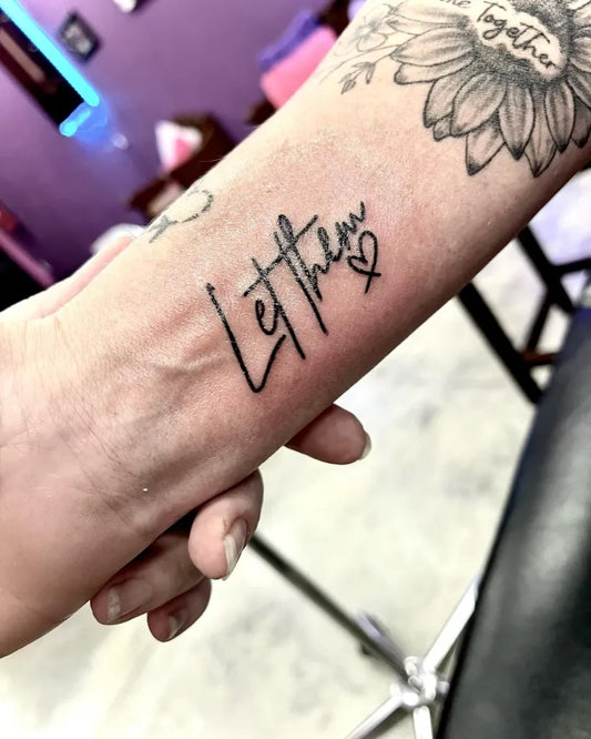 Small Script Let Them Heart on Women Forearm Tattoo by @irma.gurd