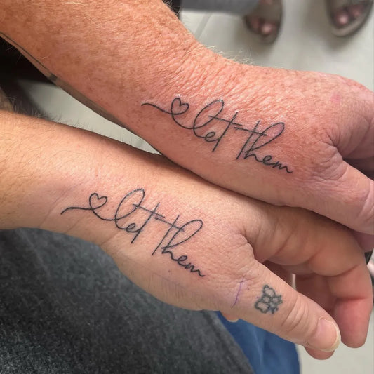 Small Script Let Them Heart on Women Hands Tattoo by @inked.by.tam