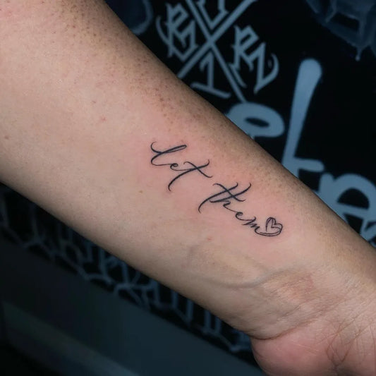 Small Script Let Them Heart on Women Wrist Tattoo by @charliebosquez
