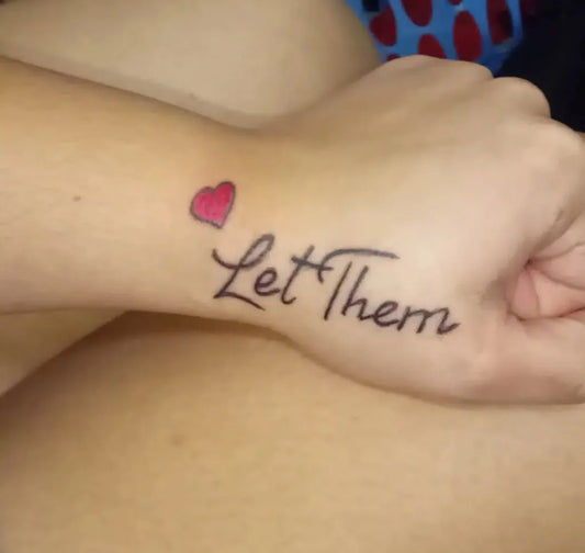 Small Script Let Them Heart on Women Wrist Tattoo by @graveyard_tattoos