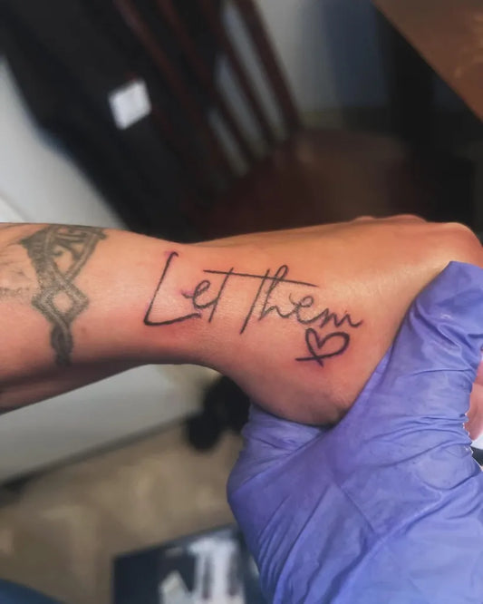 Small Script Let Them Heart on Women Wrist Tattoo by @s.dreamsstudio1517